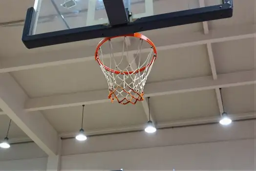 Basketball Hoop Hanging From Ceiling In Gymnasium