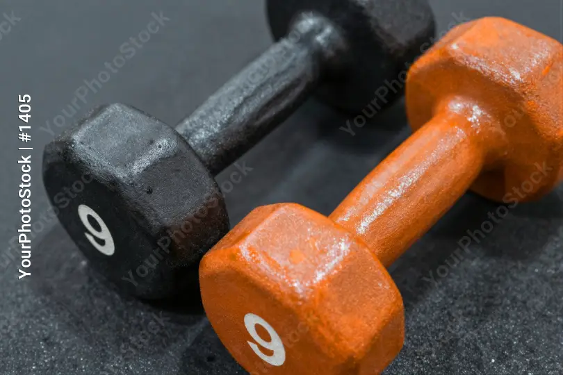 Black and Orange Dumbbells on Black Surface gym equipment