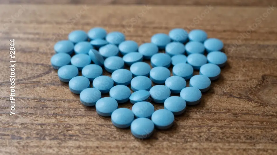 Blue Pills Arranged to Form a Heart shape