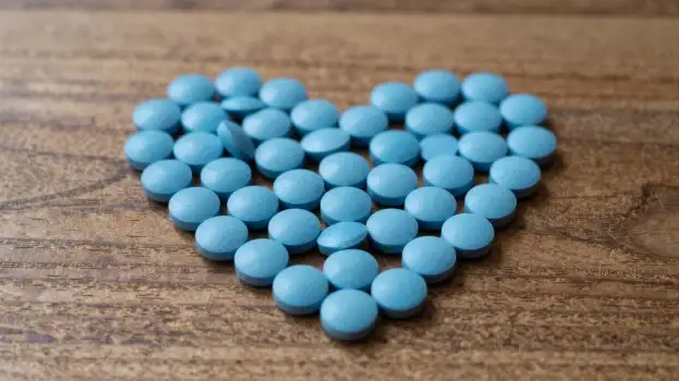 Blue Pills Arranged to Form a Heart shape