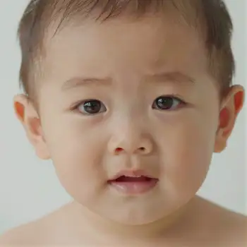 Close-up Portrait of a Smiling Baby with Wide Eyes