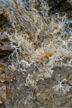 Serene Stream Over Rocks water foam peaceful nature