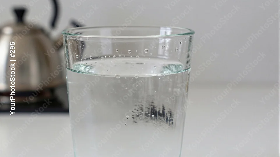 Clear Glass of Water with Bubbles on Kitchen Countertop