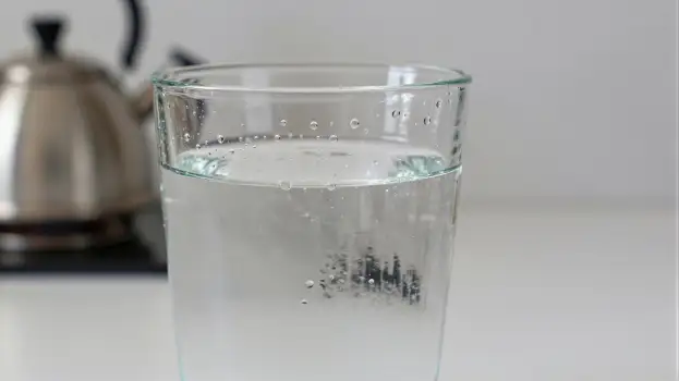 Clear Glass of Water with Bubbles on Kitchen Countertop